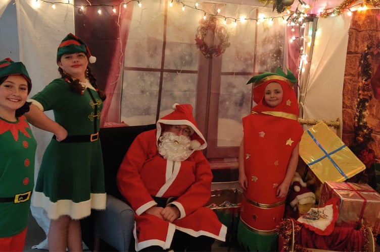 Father Christmas, elves Jingle and Jangle and the Christmas Cracker in Santa's Grotto at Alton Community Association's Christmas Cracker Fair, Alton Community Centre, December 3rd 2022.