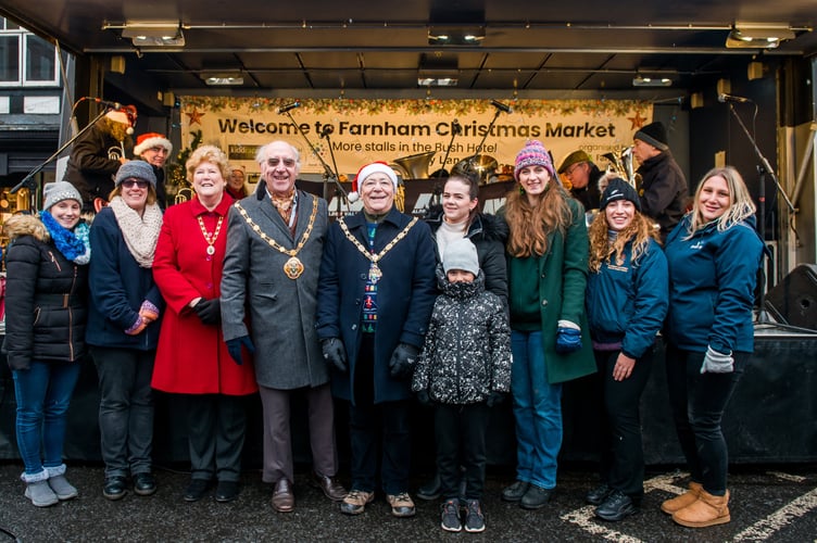 Town mayor Alan Earwaker (centre) with borough mayor John Ward and sponsors at this month’s Farnham Christmas Market