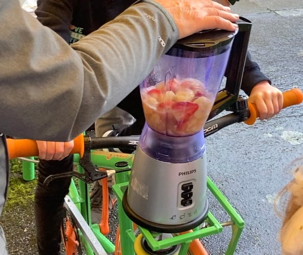 Clara Page rides the smoothie bike at Haslemere's Great Green Get Together