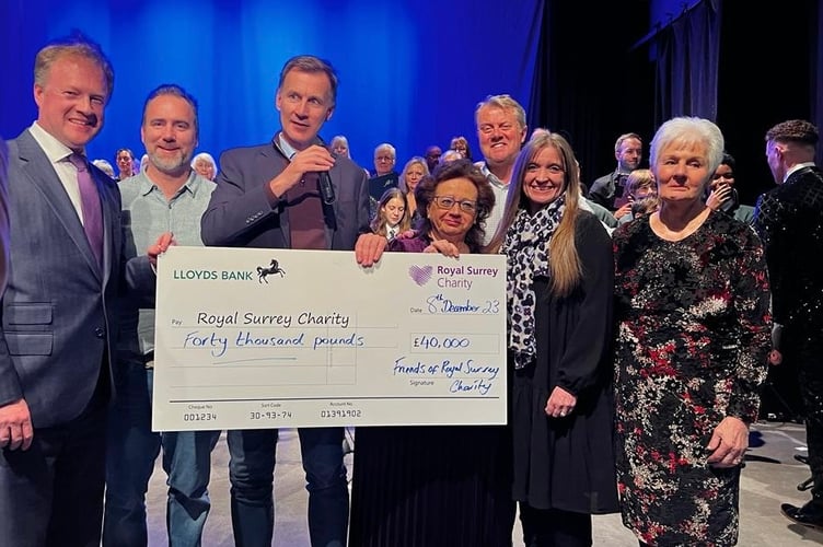 Chancellor Jeremy Hunt hands over a cheque for £40,000 to the Royal Surrey Charity towards the hospital's new cancer and surgical innovation centre