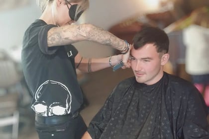 Blindfolded barbers cut hair for mental health charity