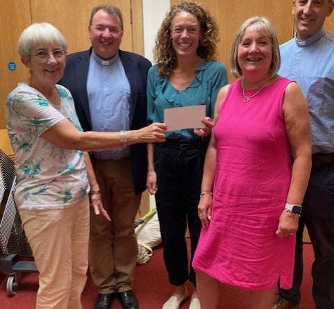 Kate Powell, centre, receives a cheque for £1,000 from Alton Methodist Church on behalf of the Anna Chaplaincy in Alton, September 2024.