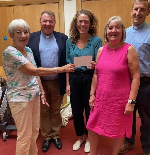 Kate Powell, centre, receives a cheque for £1,000 from Alton Methodist Church on behalf of the Anna Chaplaincy in Alton, September 2024.