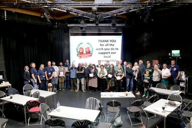 The charities receive their shares of the proceeds from the spring Alton Beer Festival.