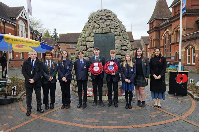 Pupils and staff from Amery Hill School lay wreaths at the Cairn war memorial in Alton High Street, November 11th 2024.