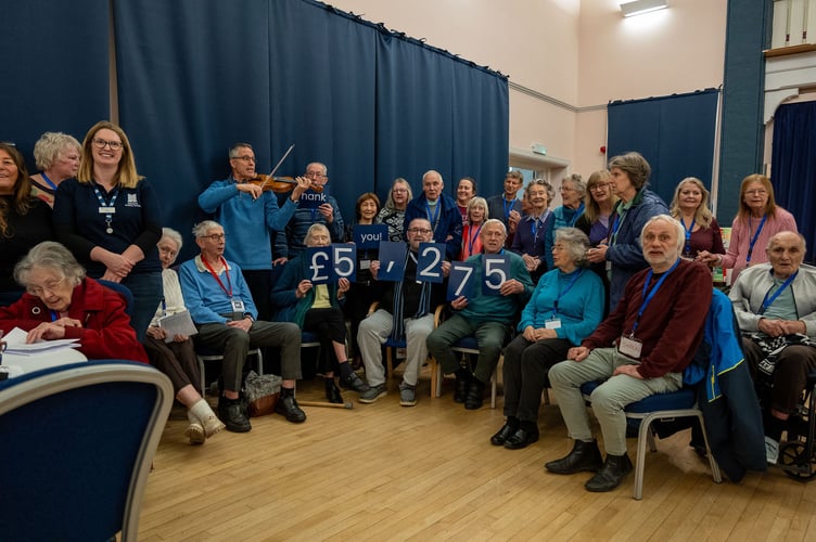 Julie Harness from Newbury Building Society celebrates raising £5,275 at a Dementia Friendly Alton event, December 2024.