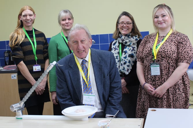 Louise Spicer, Senior Occupational Therapist, Vicky Pitt, head of Occupational Therapy, and Karen Dawson, Head of Trusts at Treloar's, and Cllr Graham Hill, EHDC Vice-Chairman, with the Neater Eater his grant helped pay for. One person unnamed. Treloar School and College, December 2024.