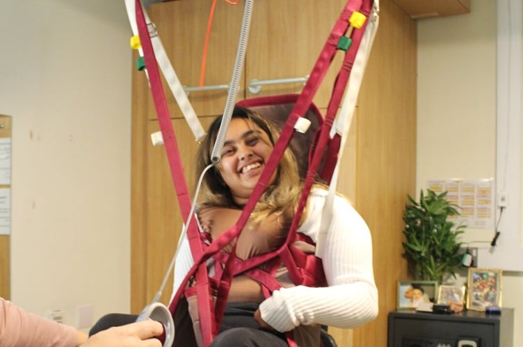 Student Amirah gets a lift in a hoist, Treloar's, December 2024.