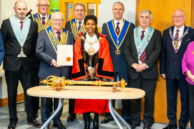 Freemasons with Rushmoor mayor Cllr Mara Makunura and the original 1924 letter of thanks for the donation of the ceremonial mace.