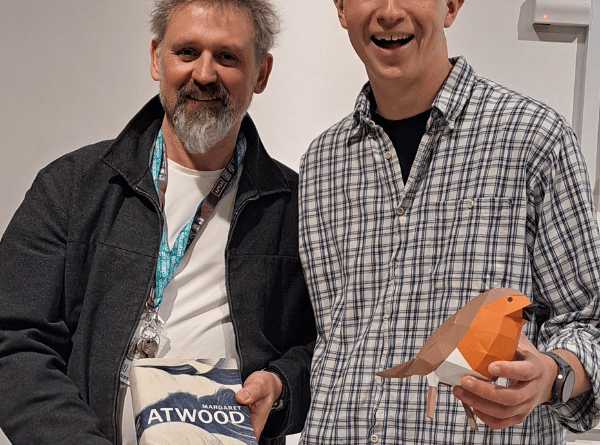 Artist Nathan Ward, right, with Alton College art lecturer Mark Taylor. Mark is holding Paper Boat by Margaret Atwood, a poetry anthology for which Nathan designed the cover, January 15th 2025.