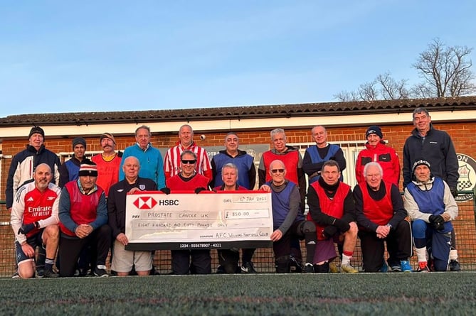 Alton Walking Football Club members with an £850 cheque for Prostate Cancer UK. Mike Graves is on the far left of the back row. Alton FC ground, January 21st 2025.