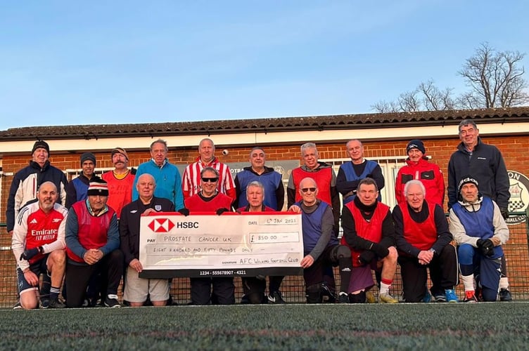 Alton Walking Football Club members with an £850 cheque for Prostate Cancer UK. Mike Graves is on the far left of the back row. Alton FC ground, January 21st 2025.