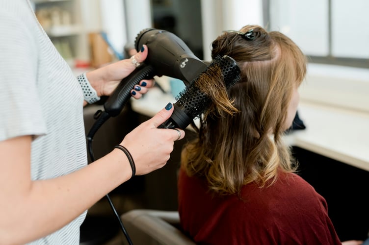 Blow drying hair.