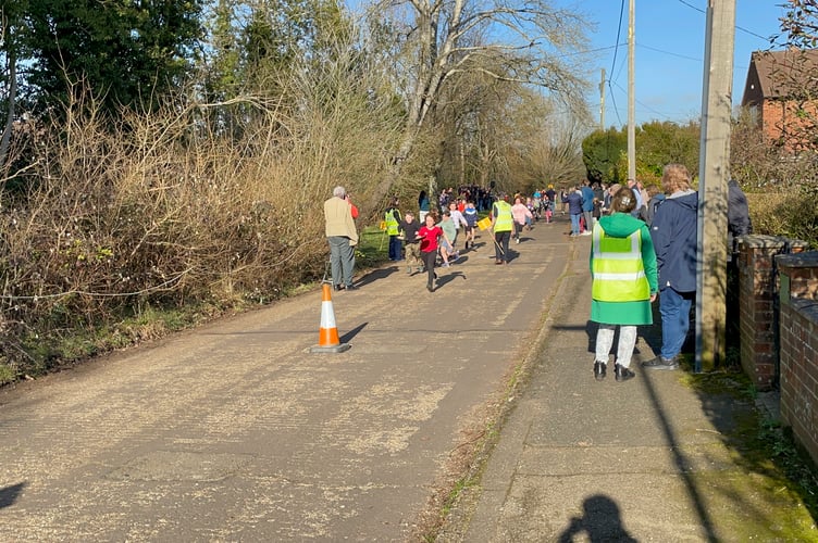 Competitors run and flip to the finish race in the Big Elstead Pancake Race.